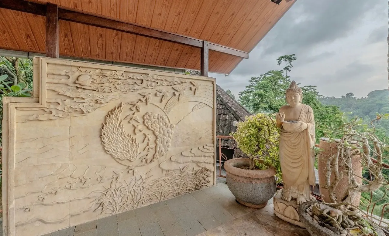 Stone relief on a terrace beside a Buddha statue