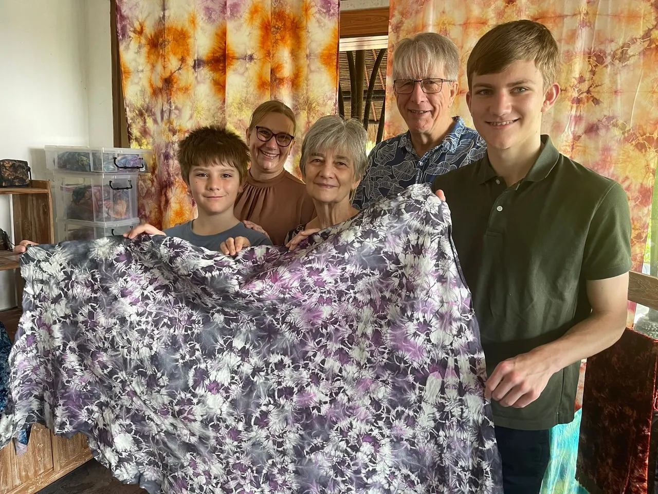 A family showing the cloth they dyed together