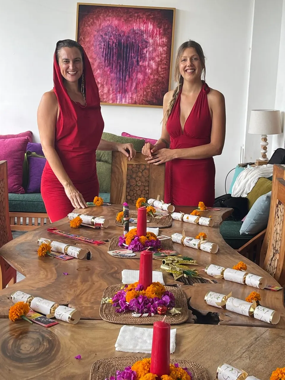 Guests setting a festive table with candles, crackers and marigolds