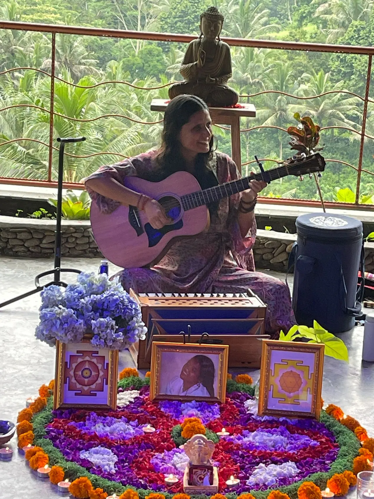 Musician playing guitar beside a flower-decorated altar