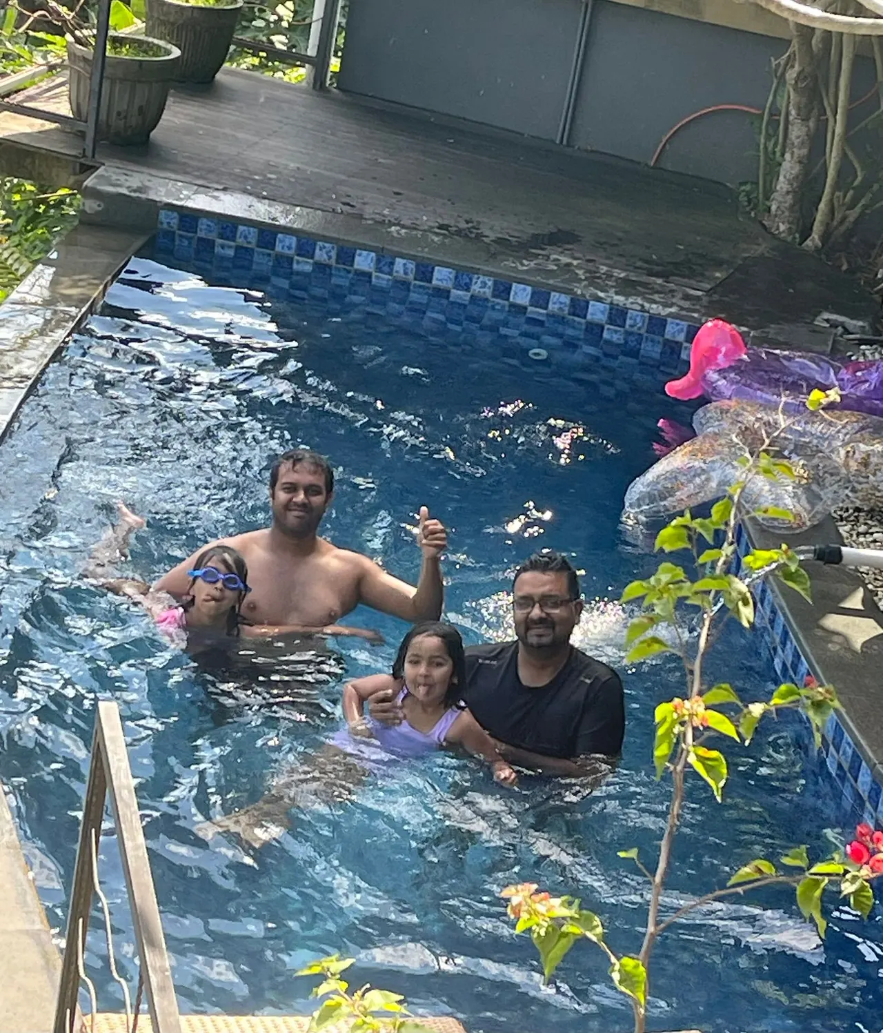 Family playing together in the pool