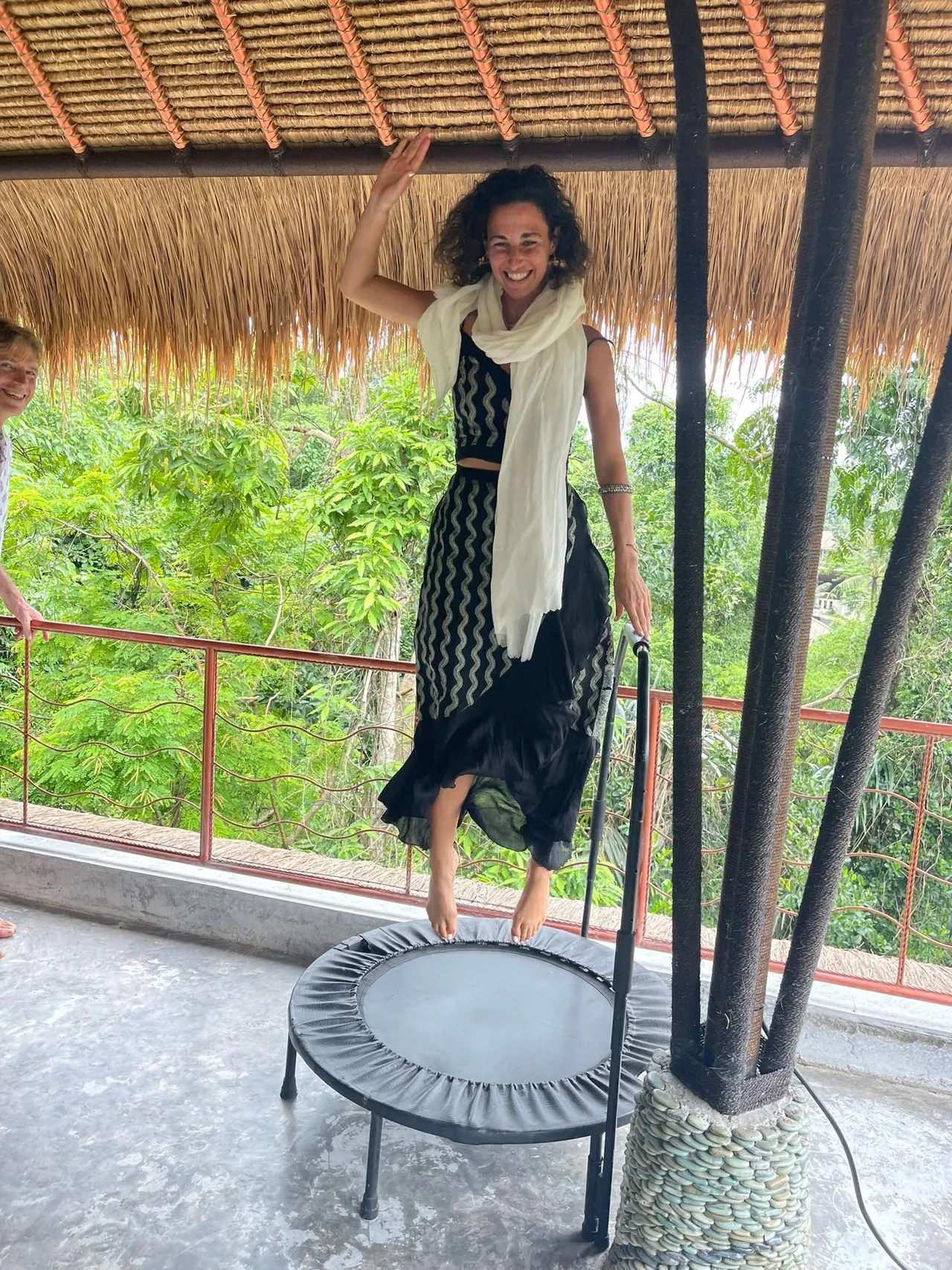Guest bouncing on a rebounder on the jungle terrace