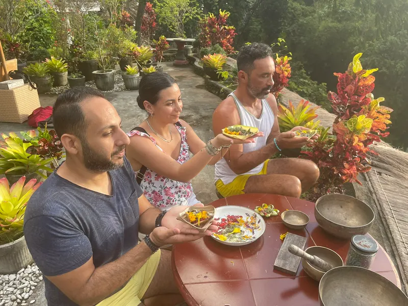 Guests crafting canang sari offerings together