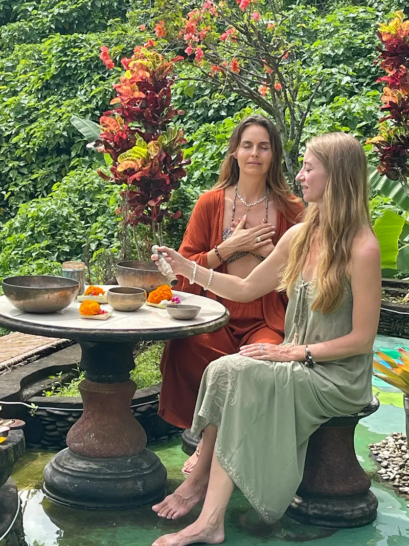 Two guests seated at the stone table in the garden