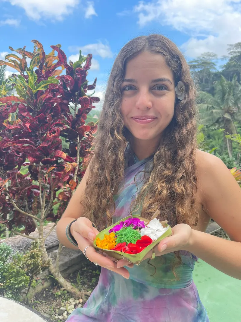 Guest holding a finished flower offering