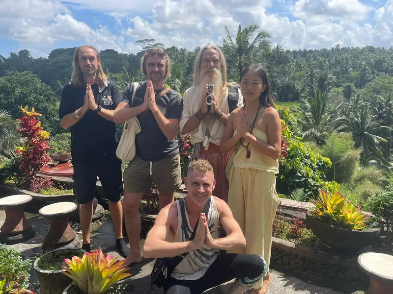 Group in prayer pose overlooking the jungle